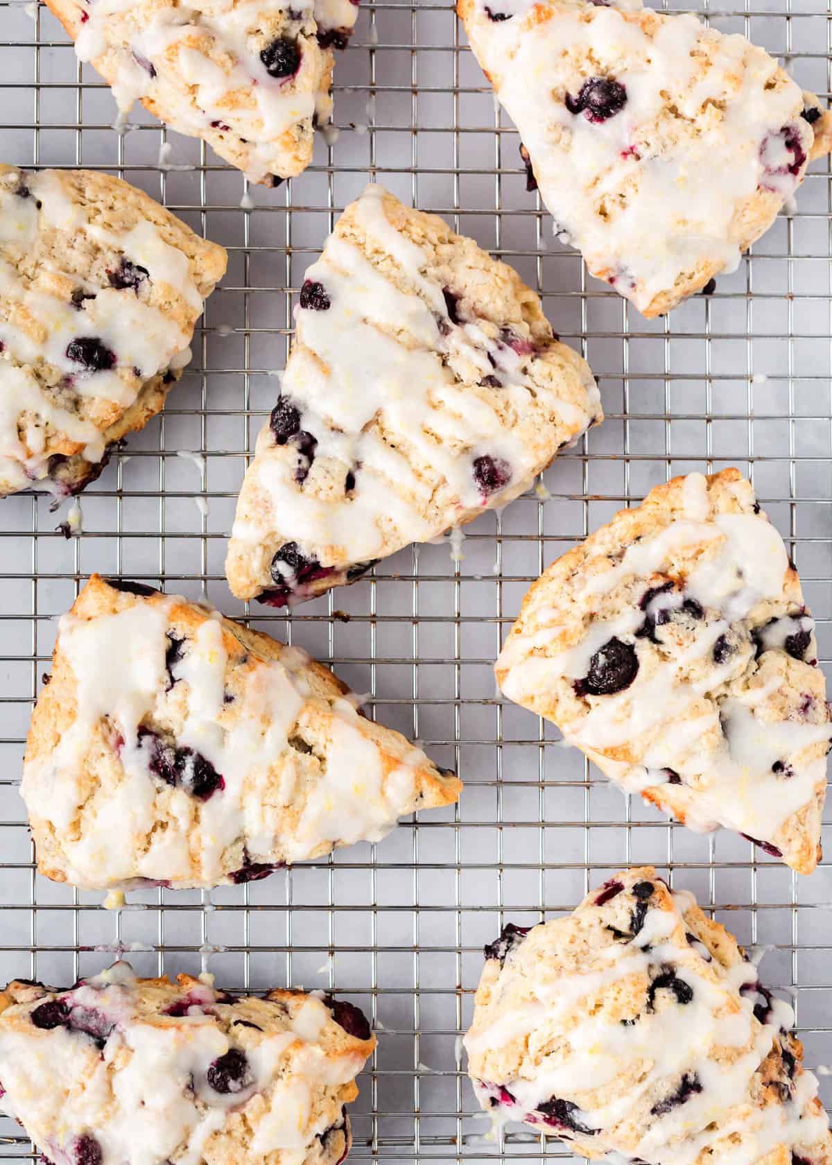 Blueberry scones on top of a cooling rack.