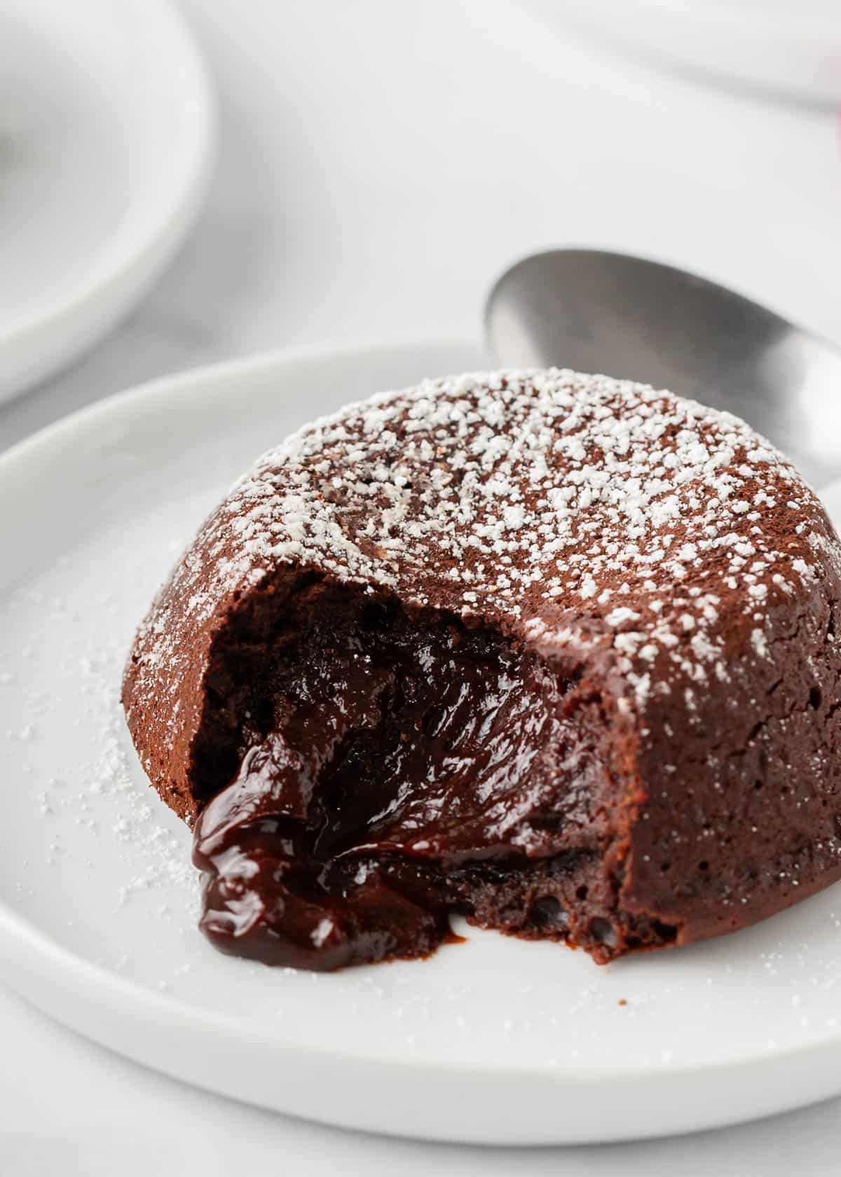 Chocolate lava cake on a white plate.