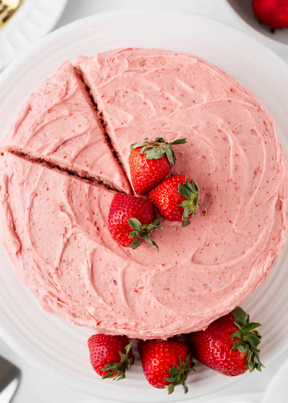 My easy-to-follow strawberry cake recipe combines homemade vanilla cake with a fresh strawberry reduction then a luscious strawberry cream cheese frosting for the ultimate strawberry delight! Strawberry cake with strawberry frosting.