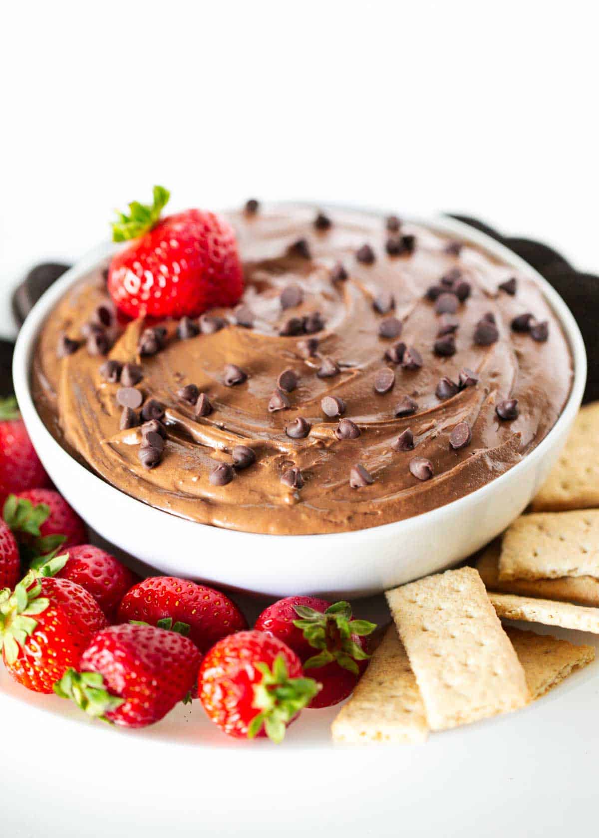 Brownie batter dip in a bowl with strawberries.