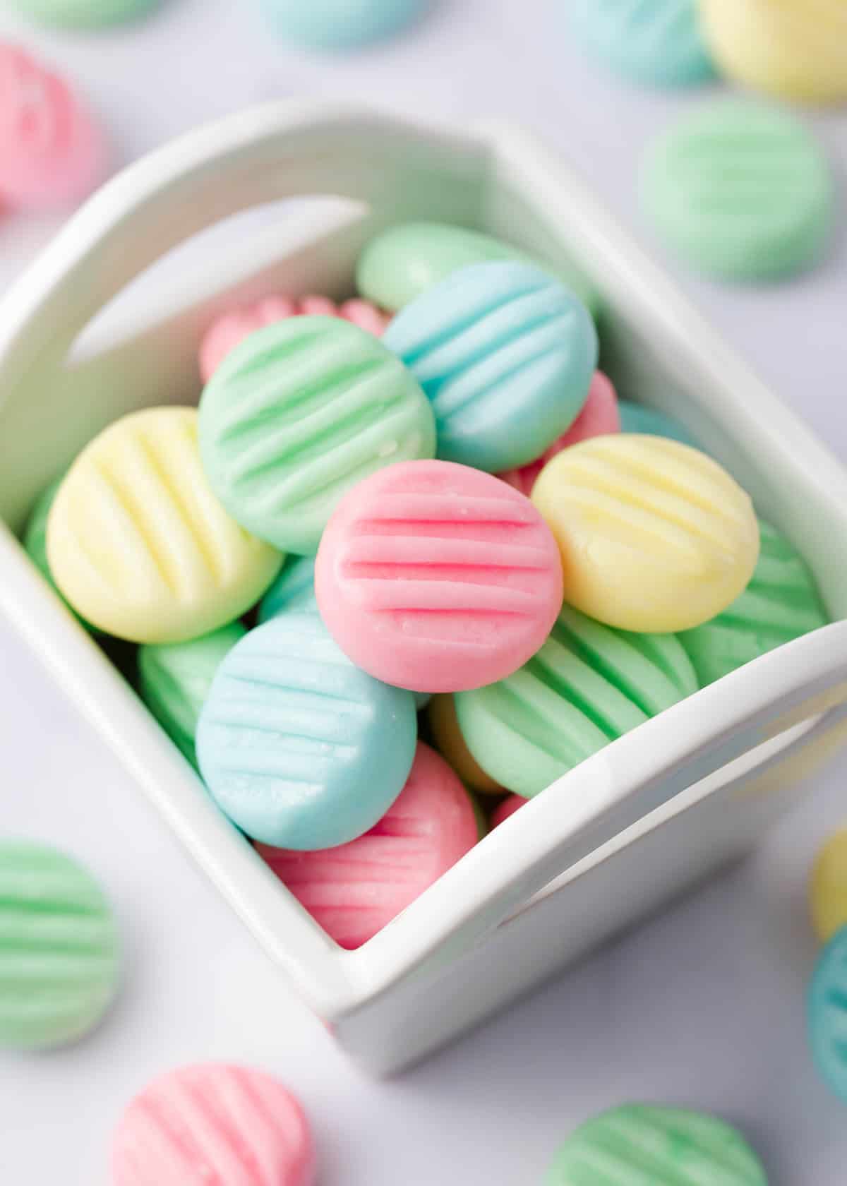 Cream cheese mints in small white container for serving.