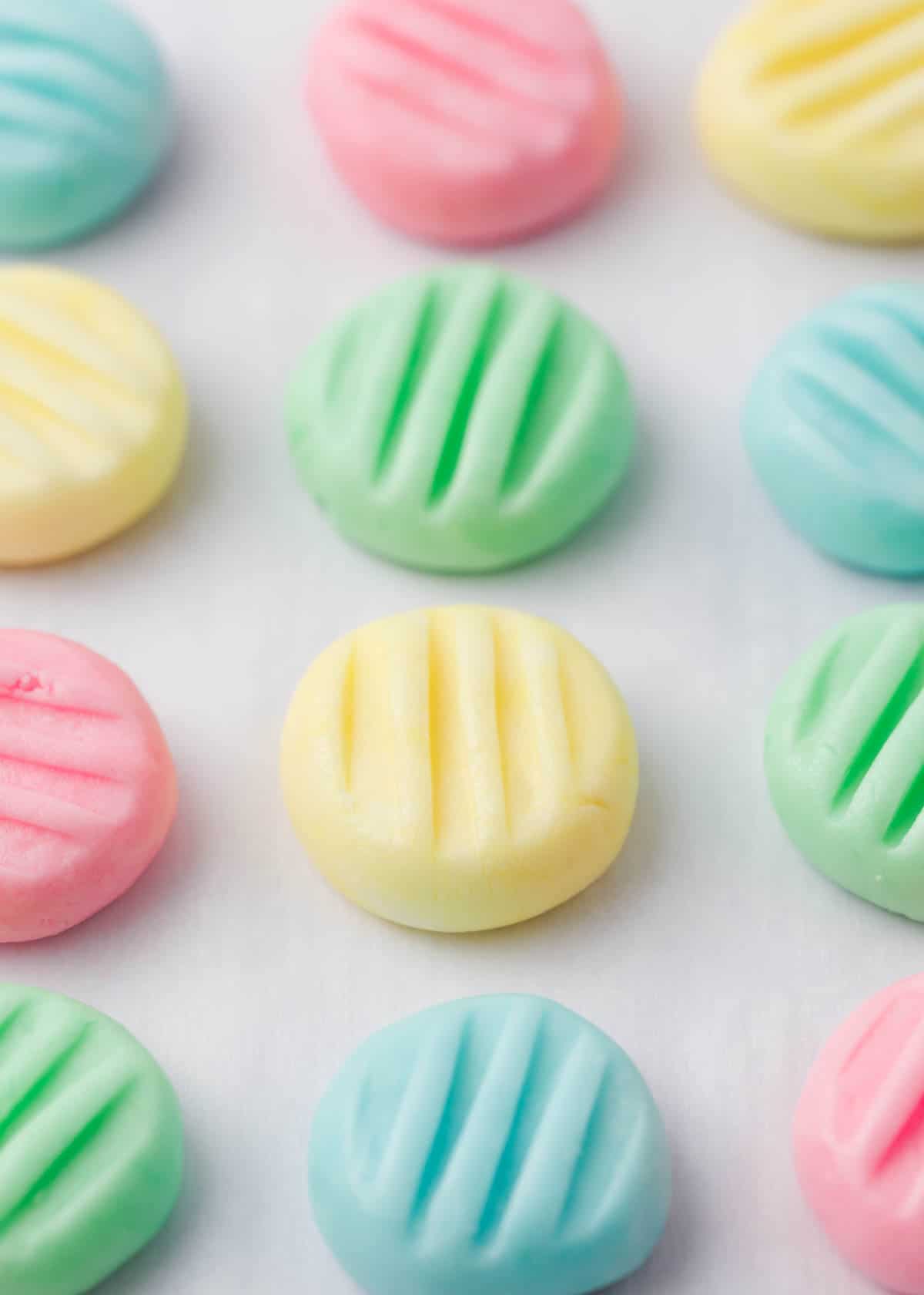 Best cream cheese mints in pastel colors on a counter.