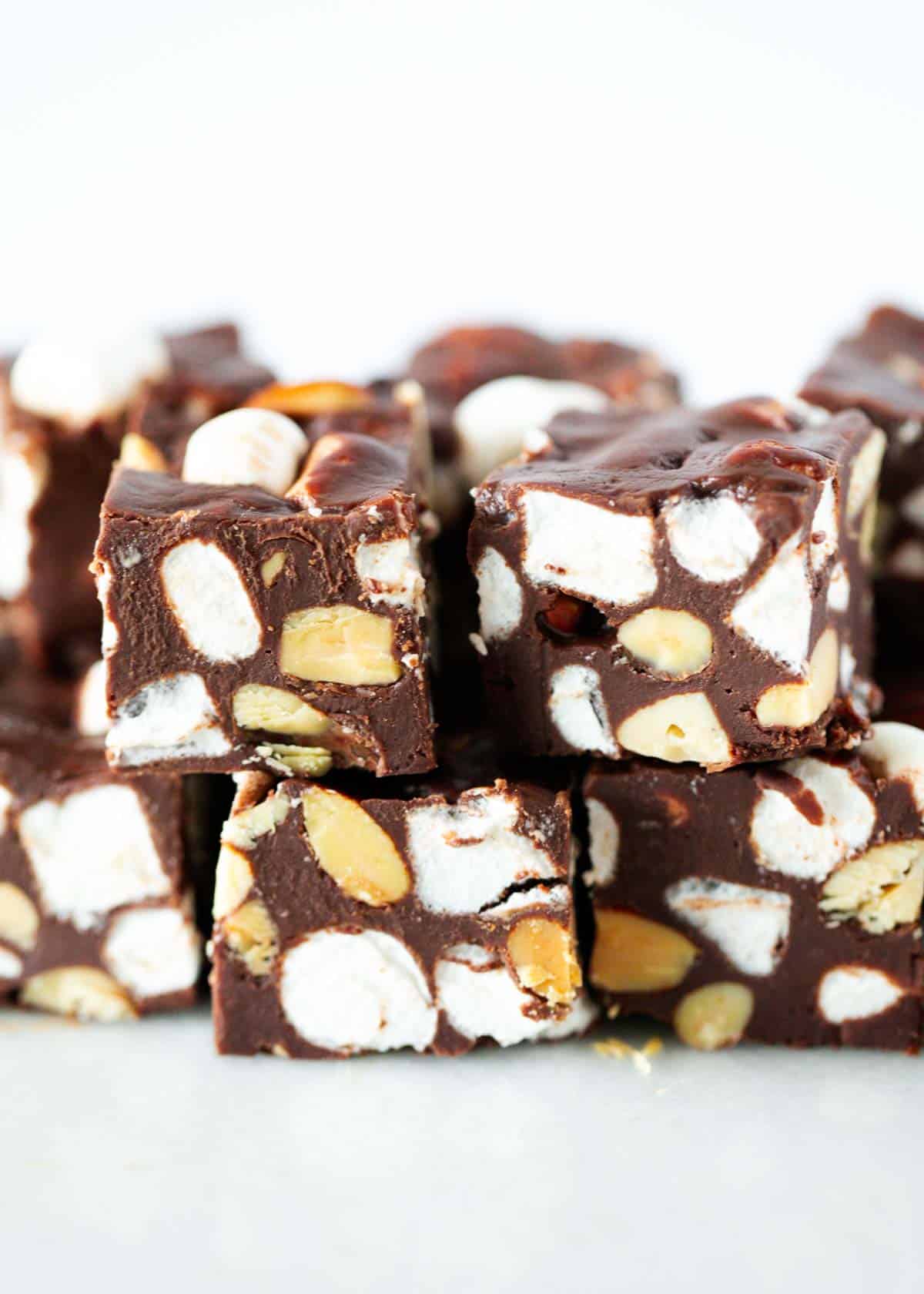 Rocky road fudge stacked on a plate.