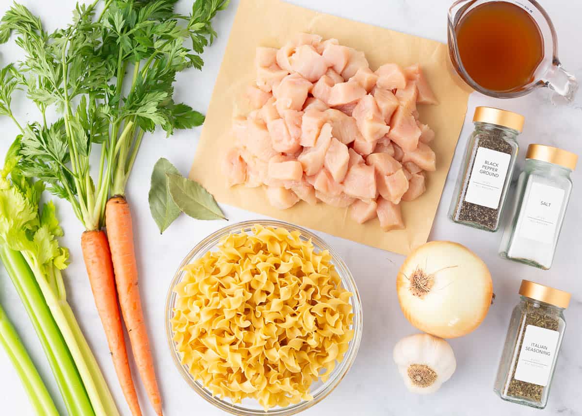 Crockpot chicken noodle soup ingredients on the counter.