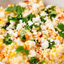 Mexican corn dip in a white bowl.