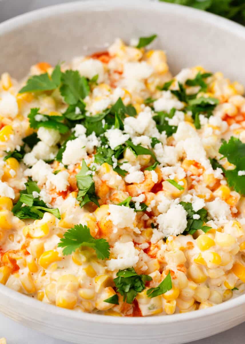 Mexican corn dip in a white bowl.