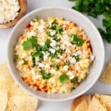 Elote dip with tortilla chips.