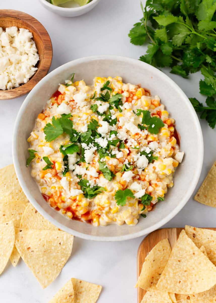 Elote dip with tortilla chips.