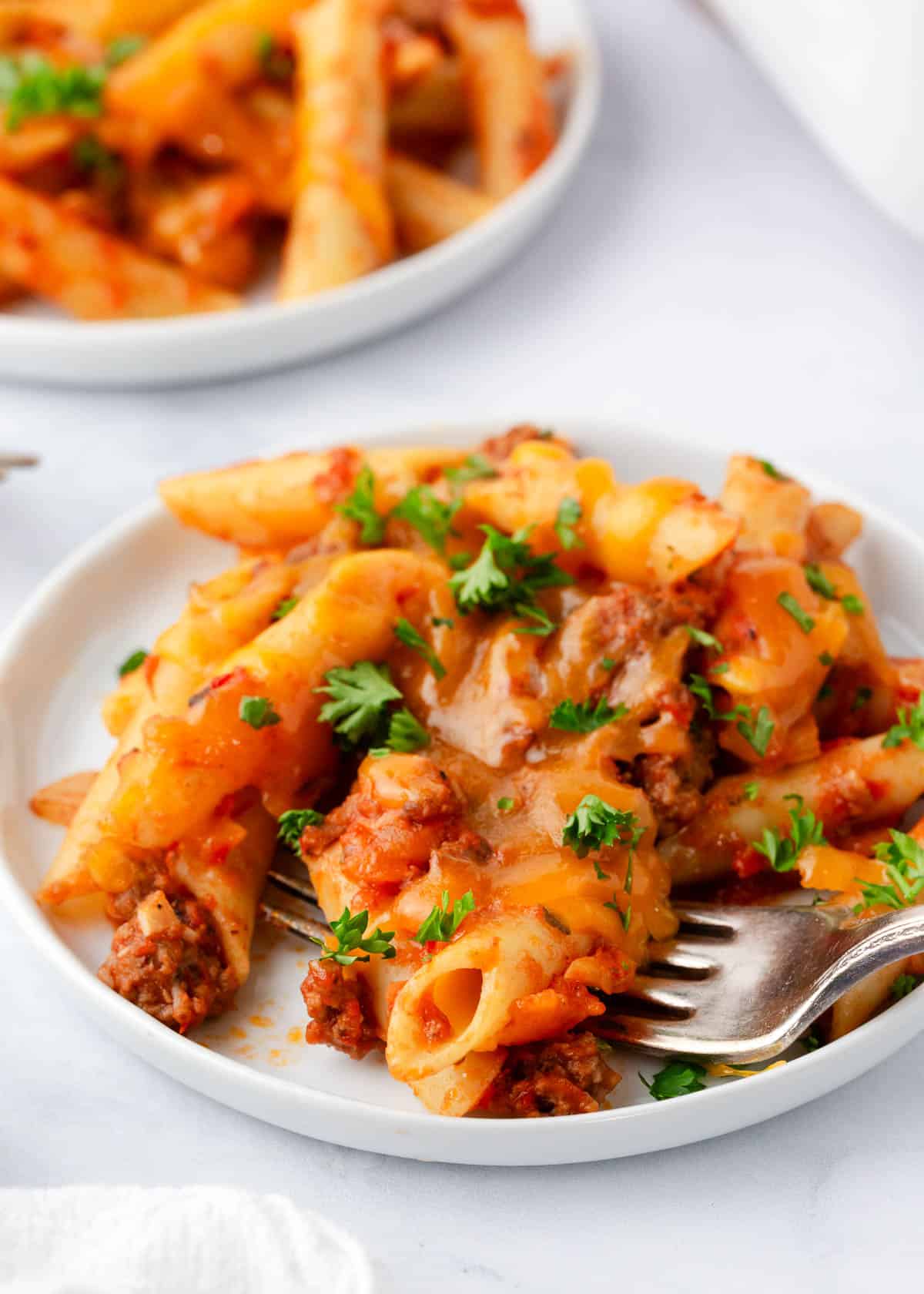 Ground beef casserole on a white plate.