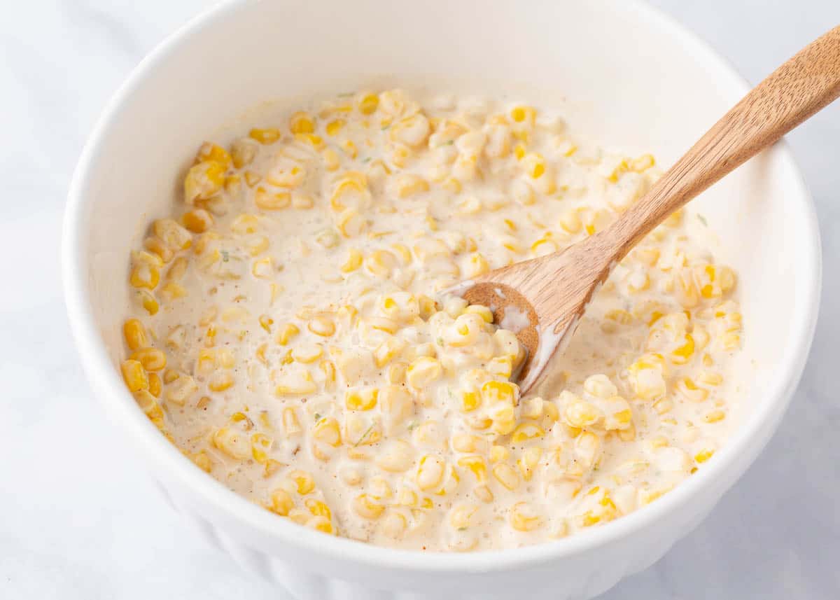 Showing how to make elote dip in a bowl.