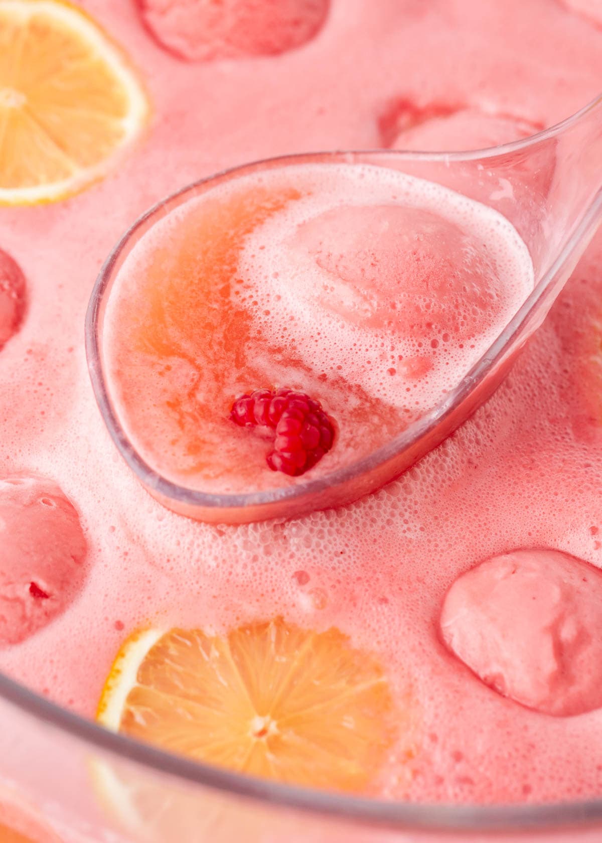Sweet, tart, refreshing, and pink! This pink punch is flavorful and fun using just 3 ingredients. It's ideal for baby showers, birthday parties, and anytime you need a quick and delicious non-alcoholic party punch recipe! Ladle full of pink punch.
