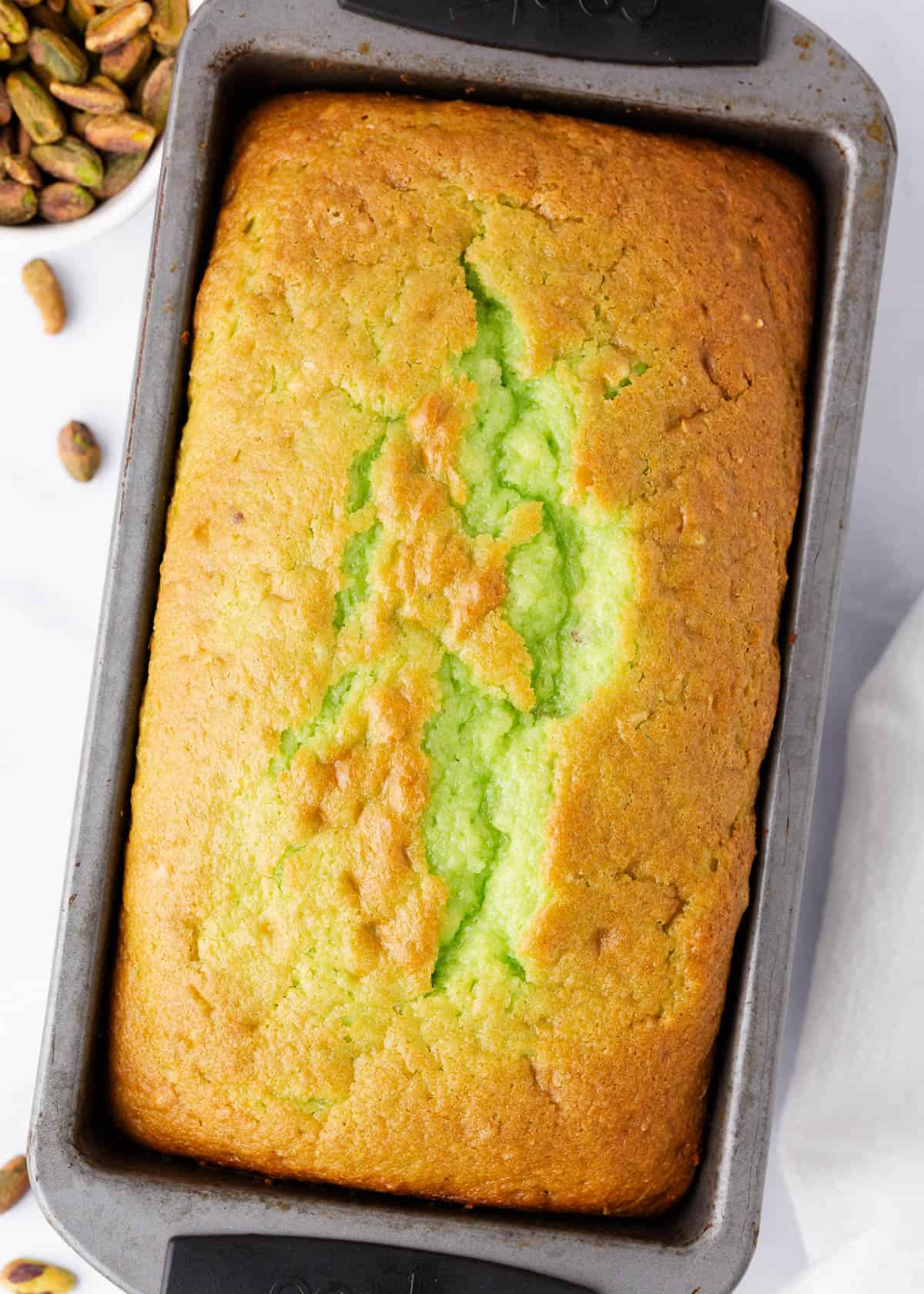 Pistachio bread in a loaf pan.
