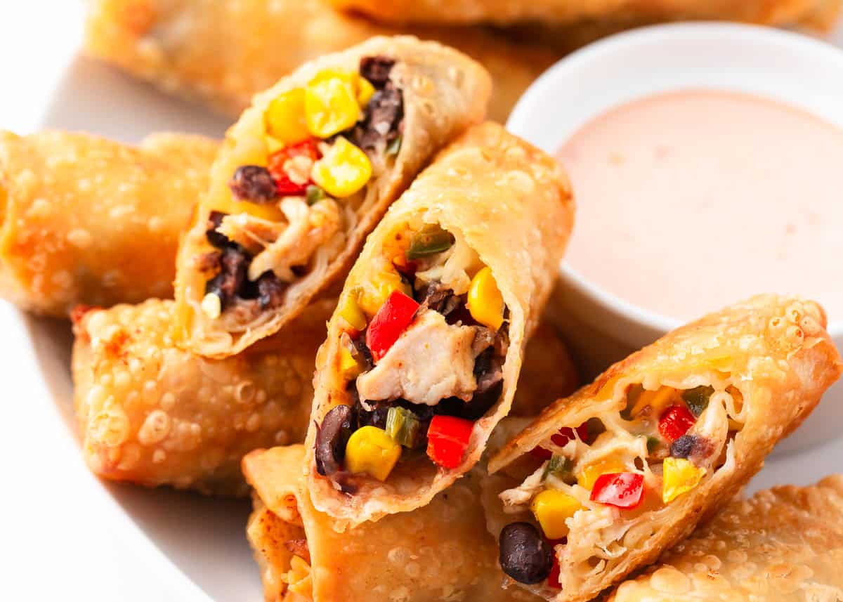 Southwest egg rolls on white plate.