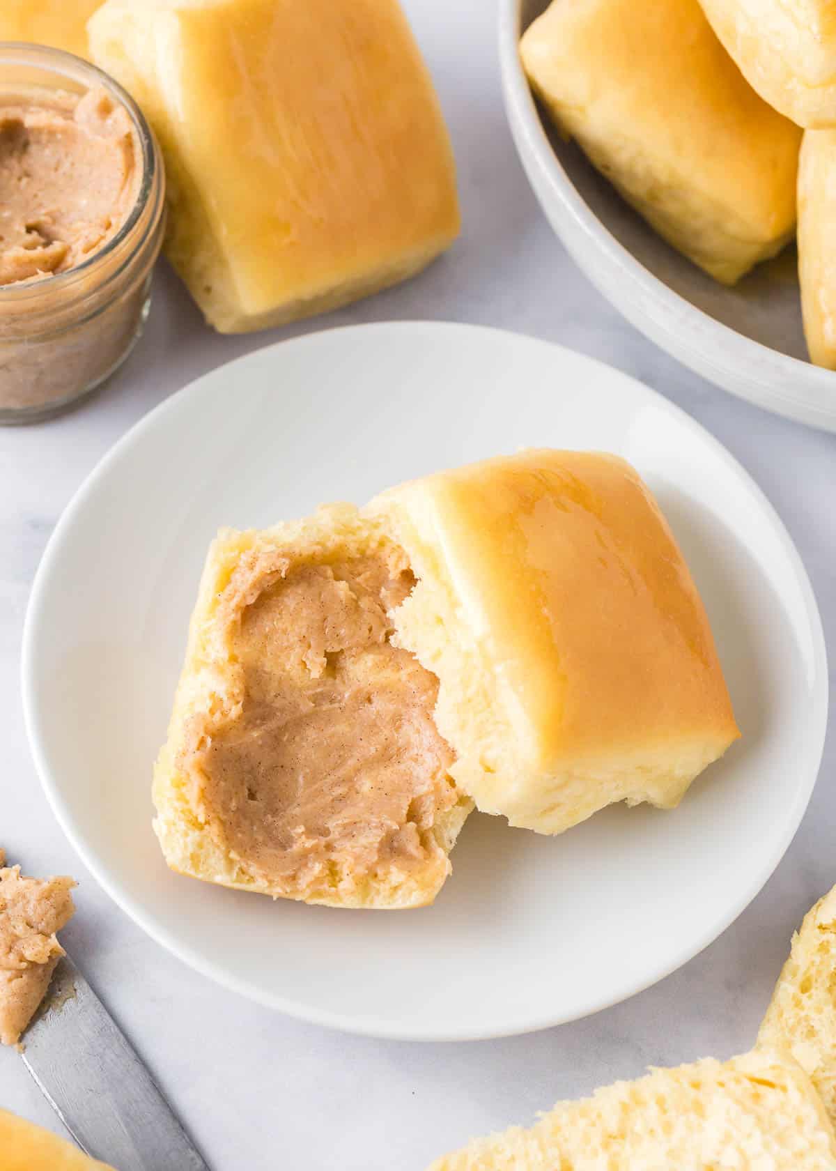 Texas Roadhouse Rolls on a plate with cinnamon butter.