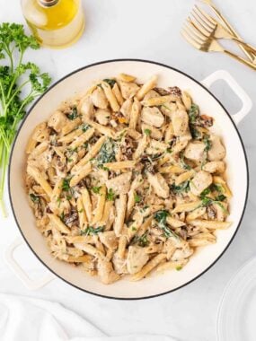 Creamy tuscan chicken pasta in a pot.
