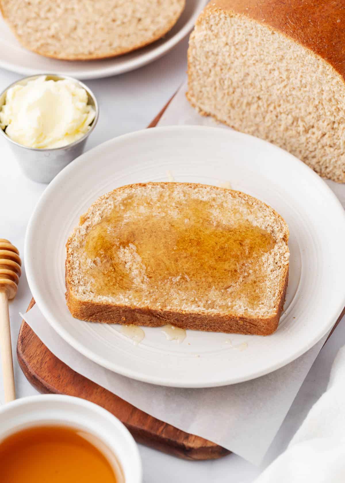 Slice of wheat bread with honey on top.