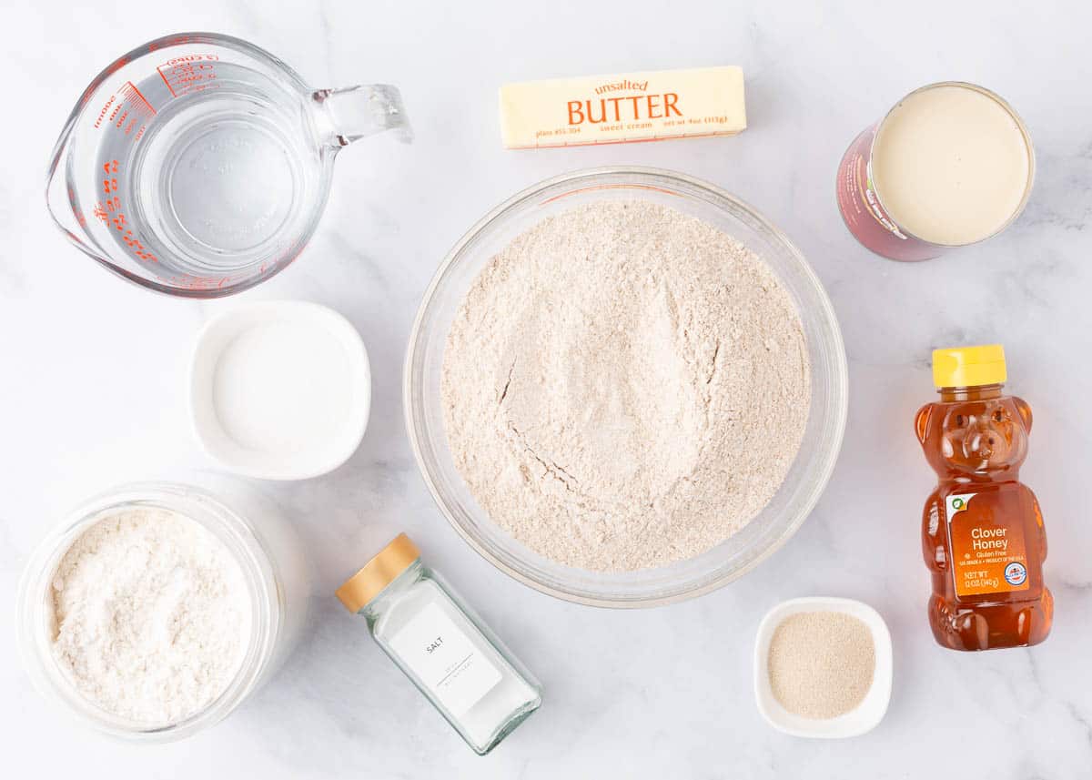 Wheat bread ingredients on a marble counter.