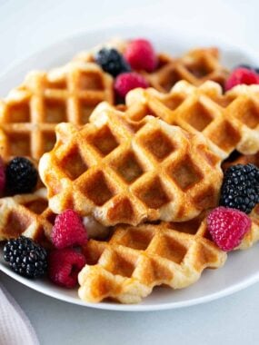 Croffle with berries on a plate.