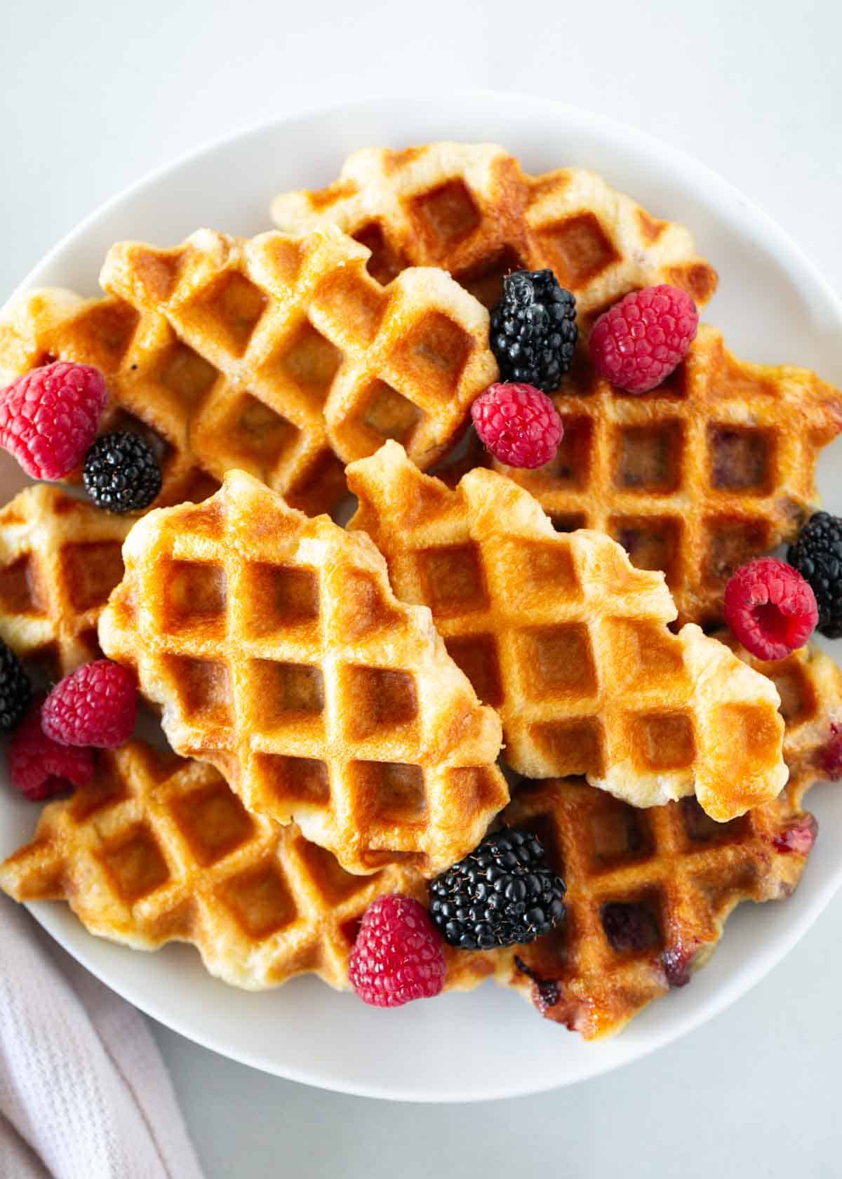 Croffles with berries on a white plate.