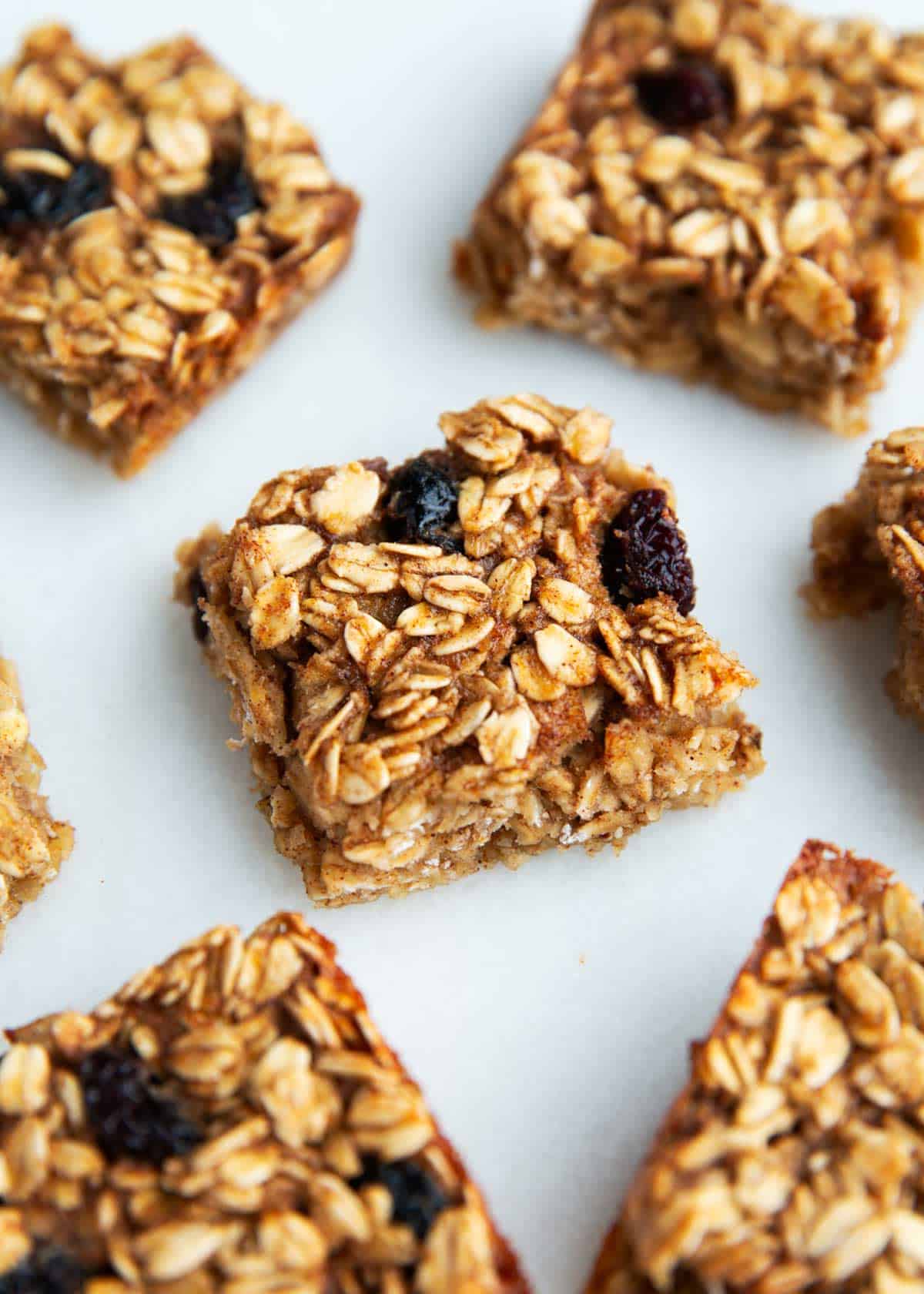 These oatmeal breakfast bars are soft, chewy and a healthy start to the day! They are quick and easy to meal prep in advance for breakfast and snacks. Oatmeal breakfast bars cut into pieces on the counter.