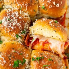 Pepperoni pizza sliders made with Hawaiian rolls, baked with melted mozzarella cheese and brushed with garlic butter.