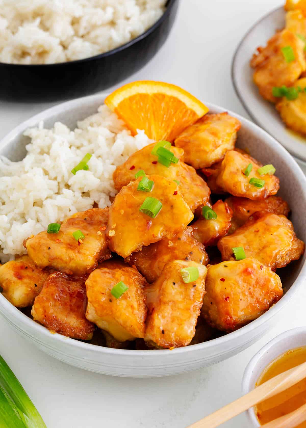 PF chang's orange chicken and rice in a white bowl.