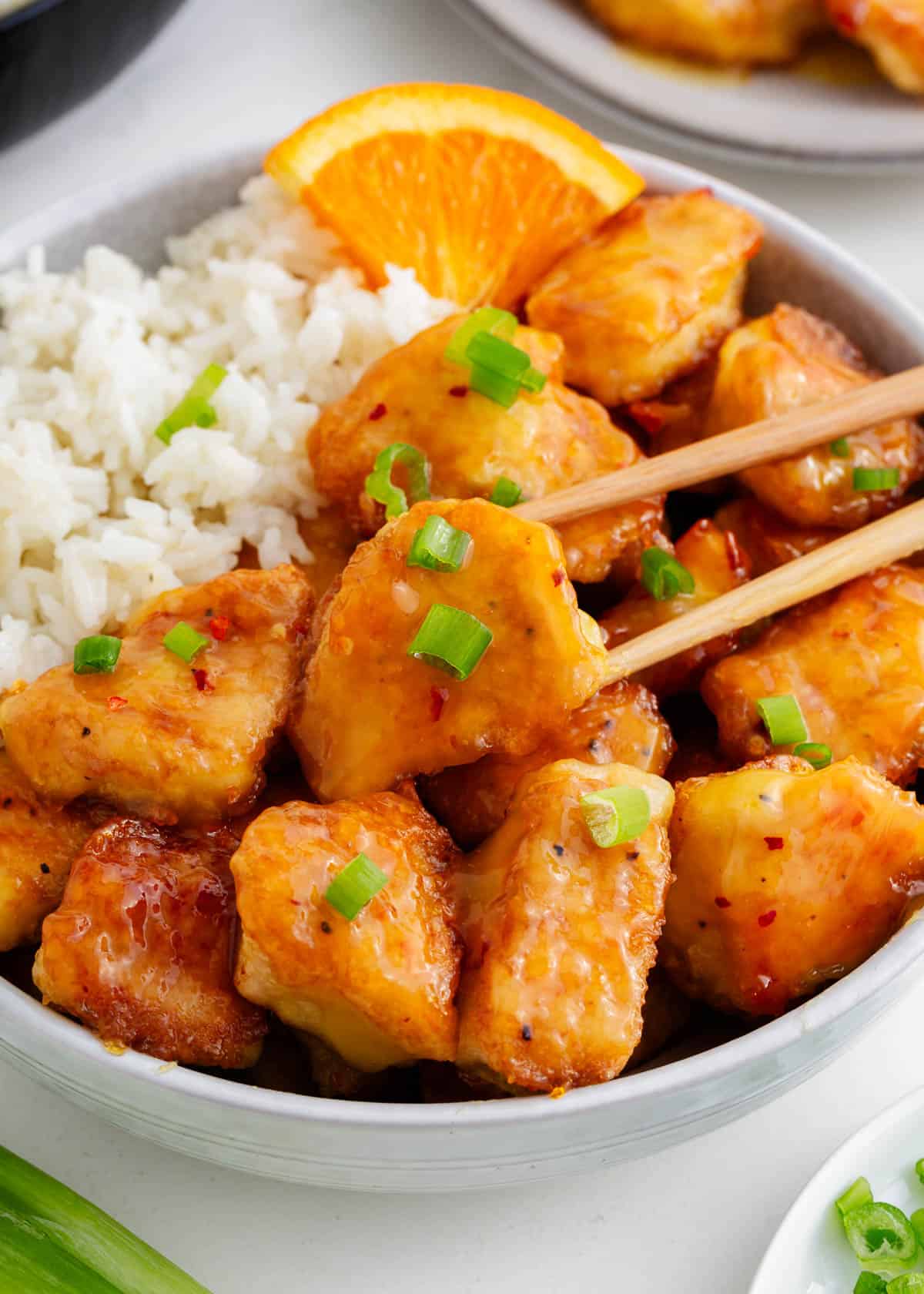 Orange chicken and rice in a bowl.