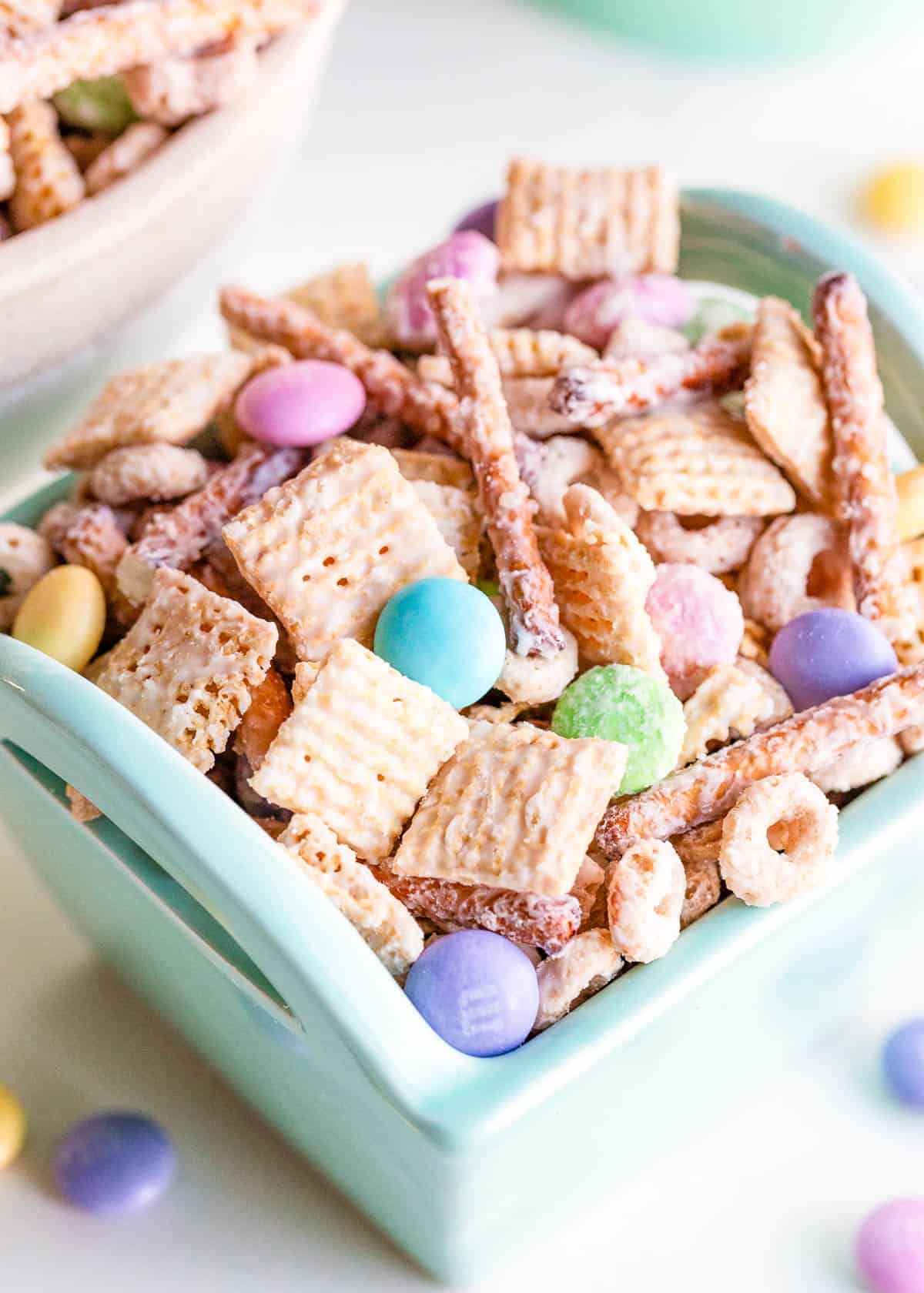 Whip up a batch of irresistible bunny bait for Easter! With a perfect balance of sweet and salty flavors, this snack mix is ideal for parties, gifts, or a special family treat. Bunny bait in a blue container.