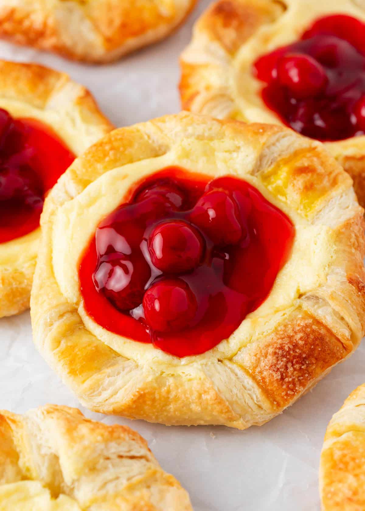 Cherry cheese danish on a plate.