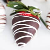 Chocolate covered strawberries on a plate.