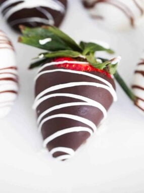 Chocolate covered strawberries on a plate.
