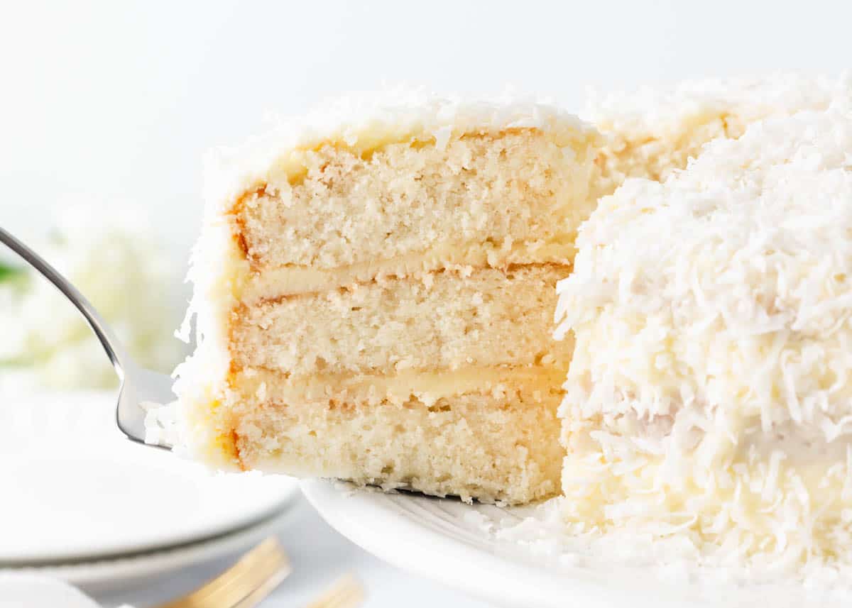 Getting a slice of coconut cake.