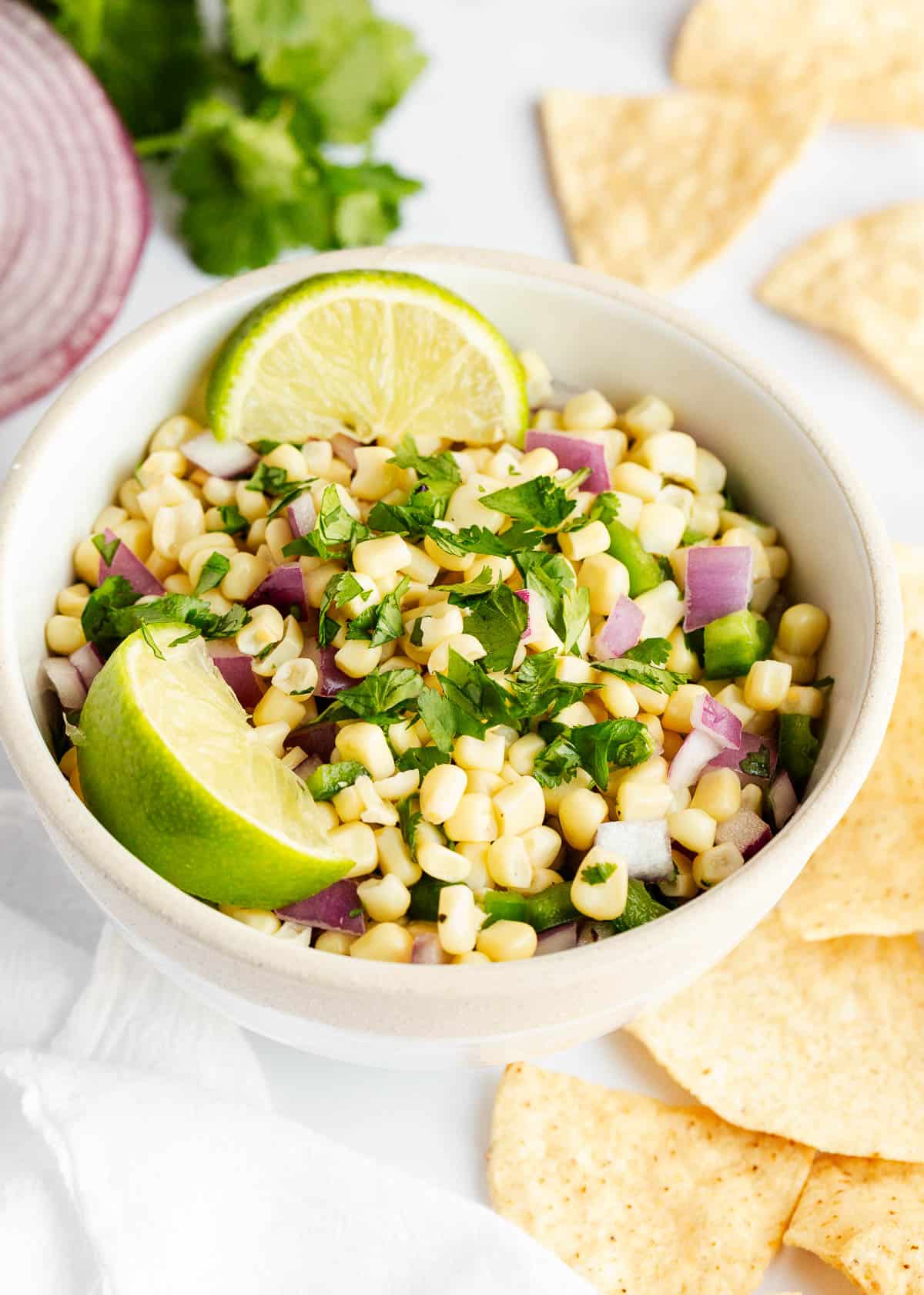 Bring Chipotle's flavors home with my copycat corn salsa recipe! Simple, fresh, and bursting with flavor, it's the perfect addition to your tacos and grilled meats. Corn salsa in a bowl.