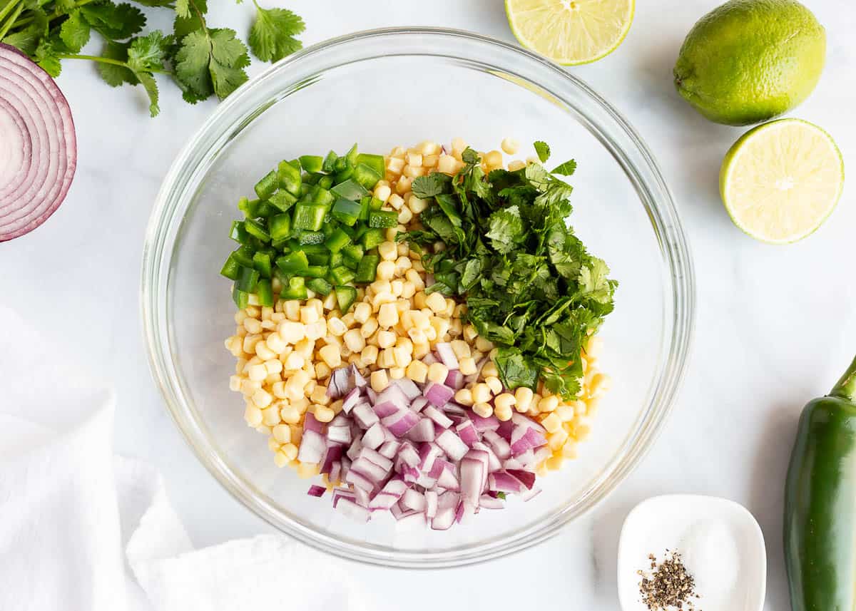 Showing how to make corn salsa.