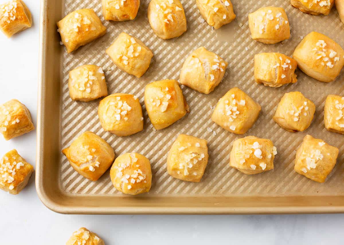 Pretzel bites on gold baking sheet.