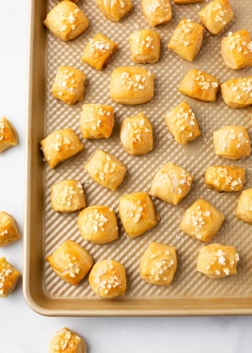 Pretzel bites on gold baking sheet.