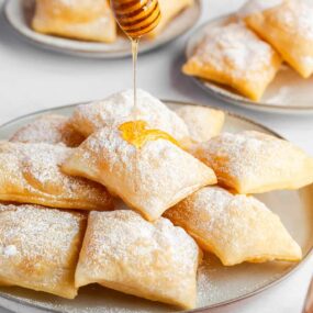 Drizzling honey on top of sopapillas.