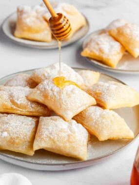Drizzling honey on top of sopapillas.