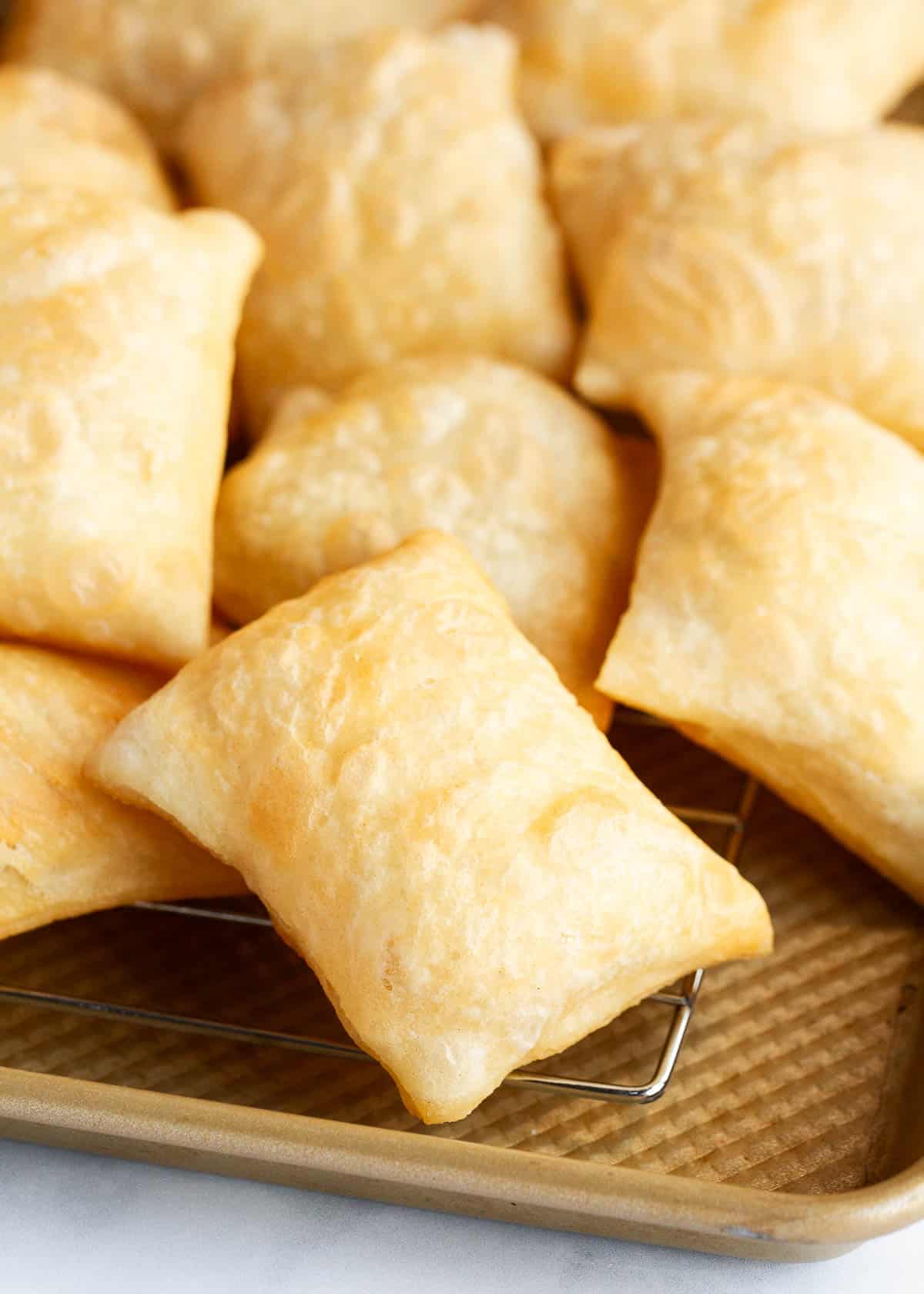 Sopapillas on a baking sheet.