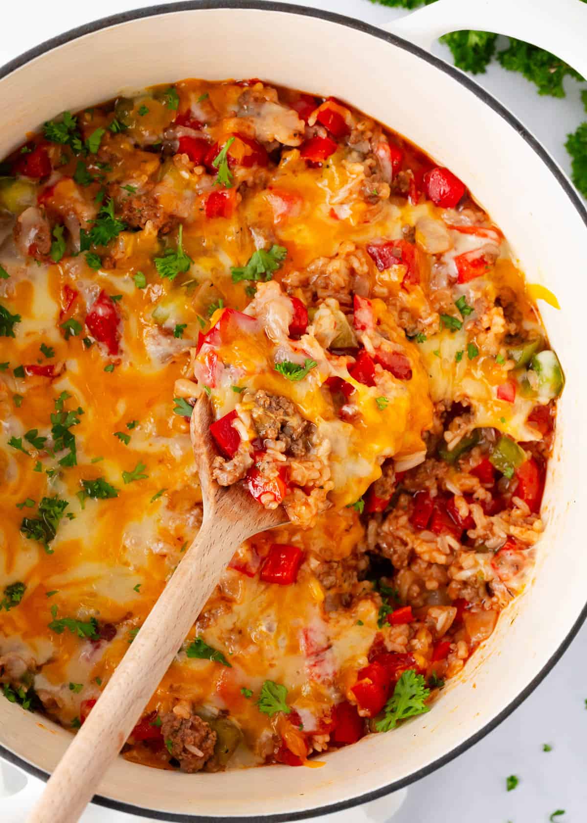 Stuffed pepper casserole cooking in a white pot.