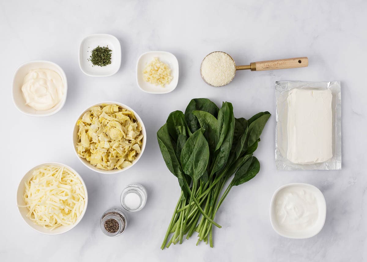 Oven baked spinach artichoke dip ingredients on counter.