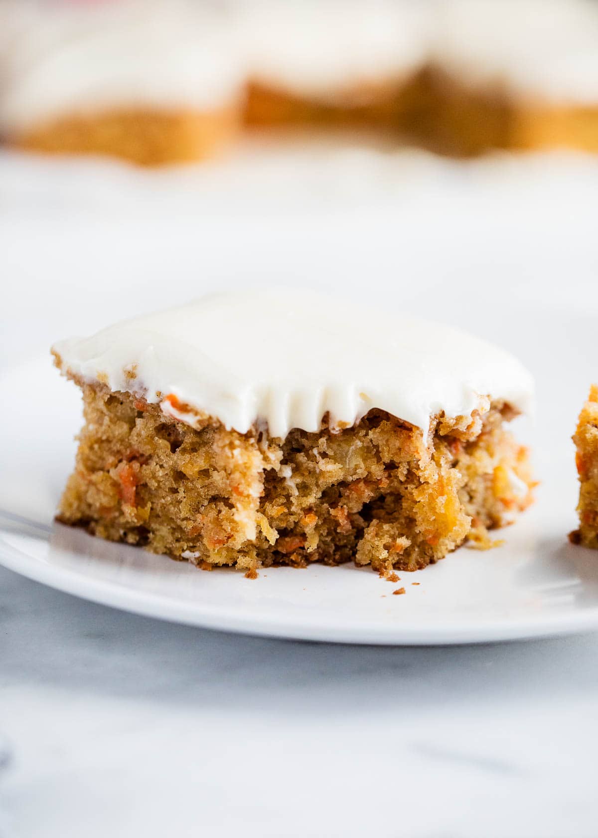Slice of carrot cake on a plate.