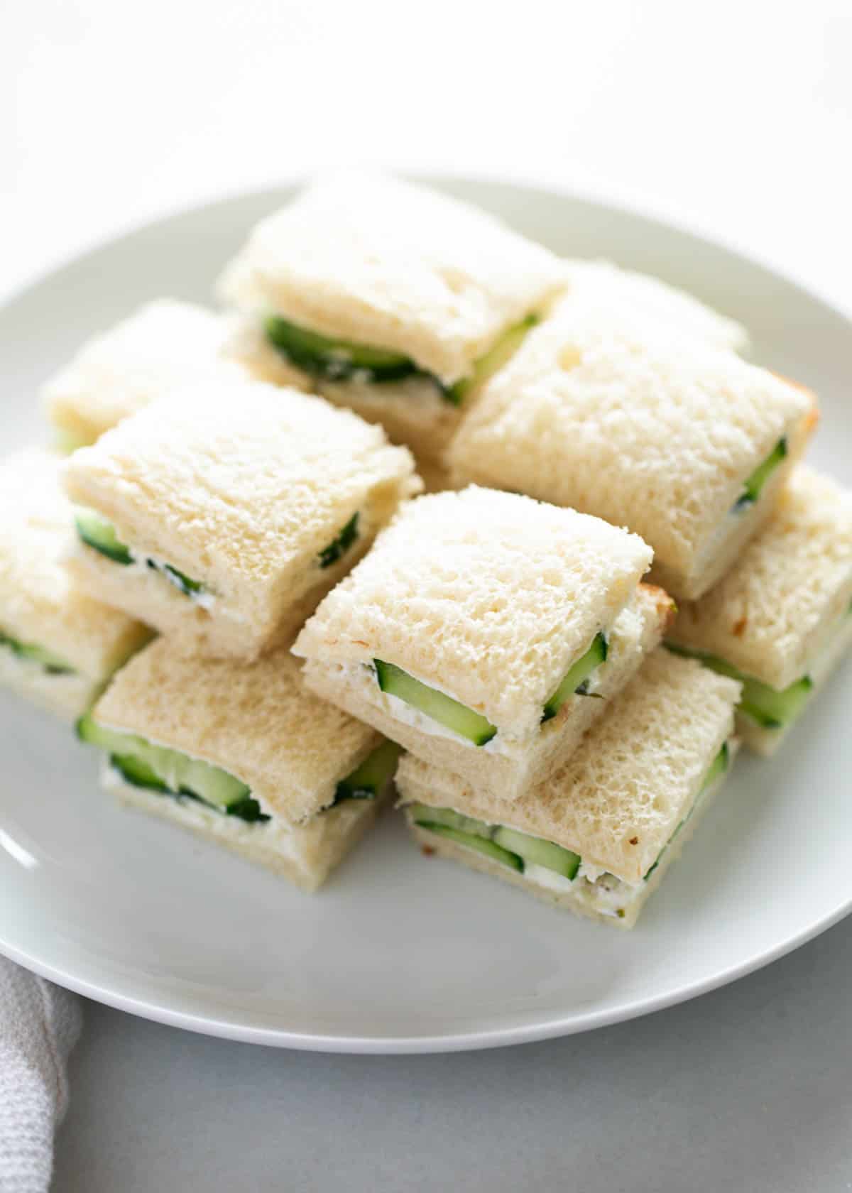 Cucumber sandwiches on a plate.