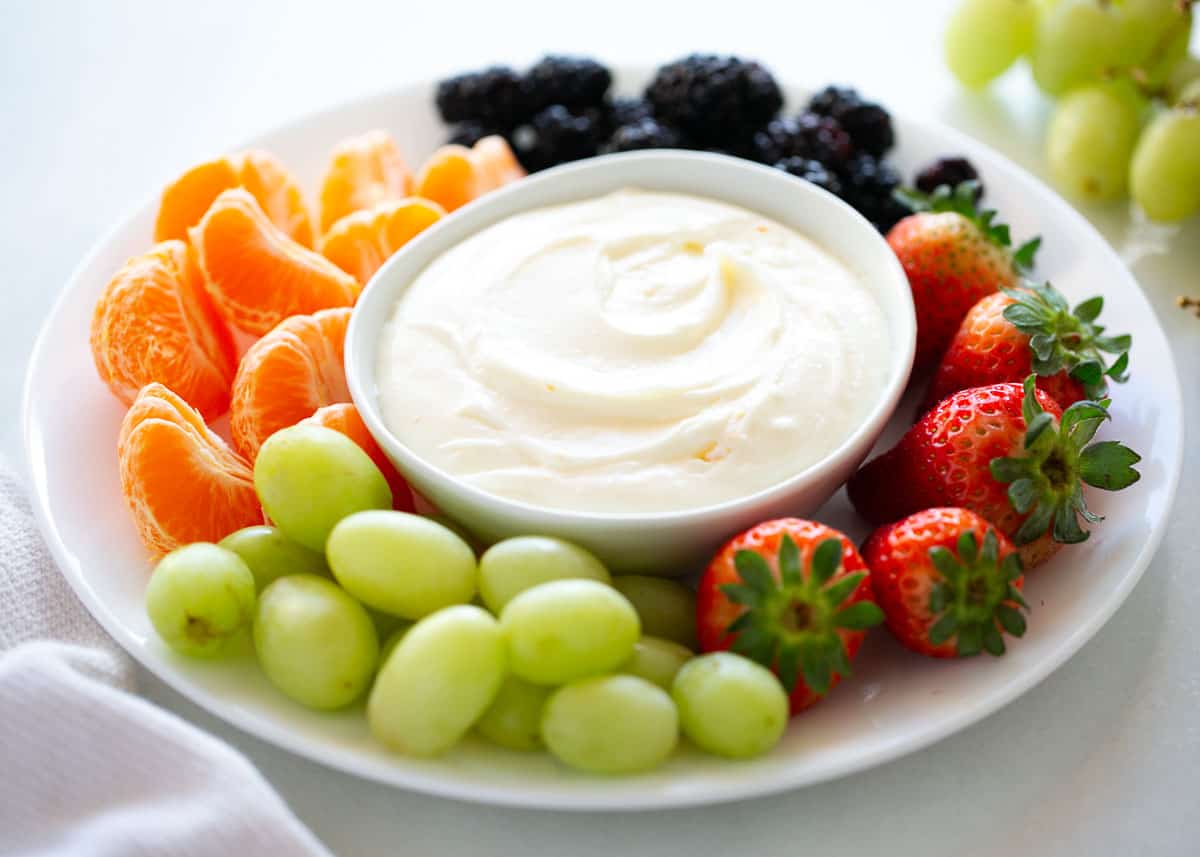 Fruit dip and fruit on a plate.