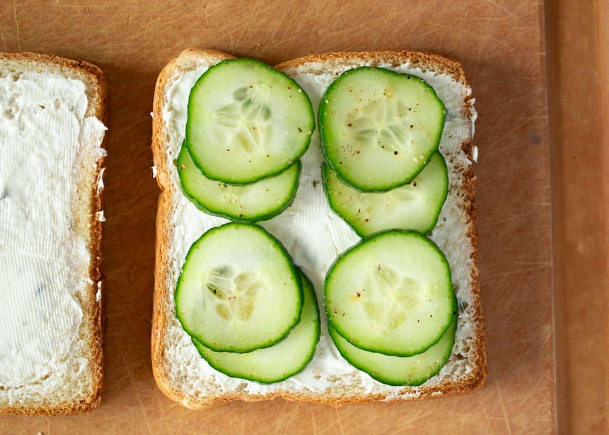Showing how to make a cucumber sandwich.