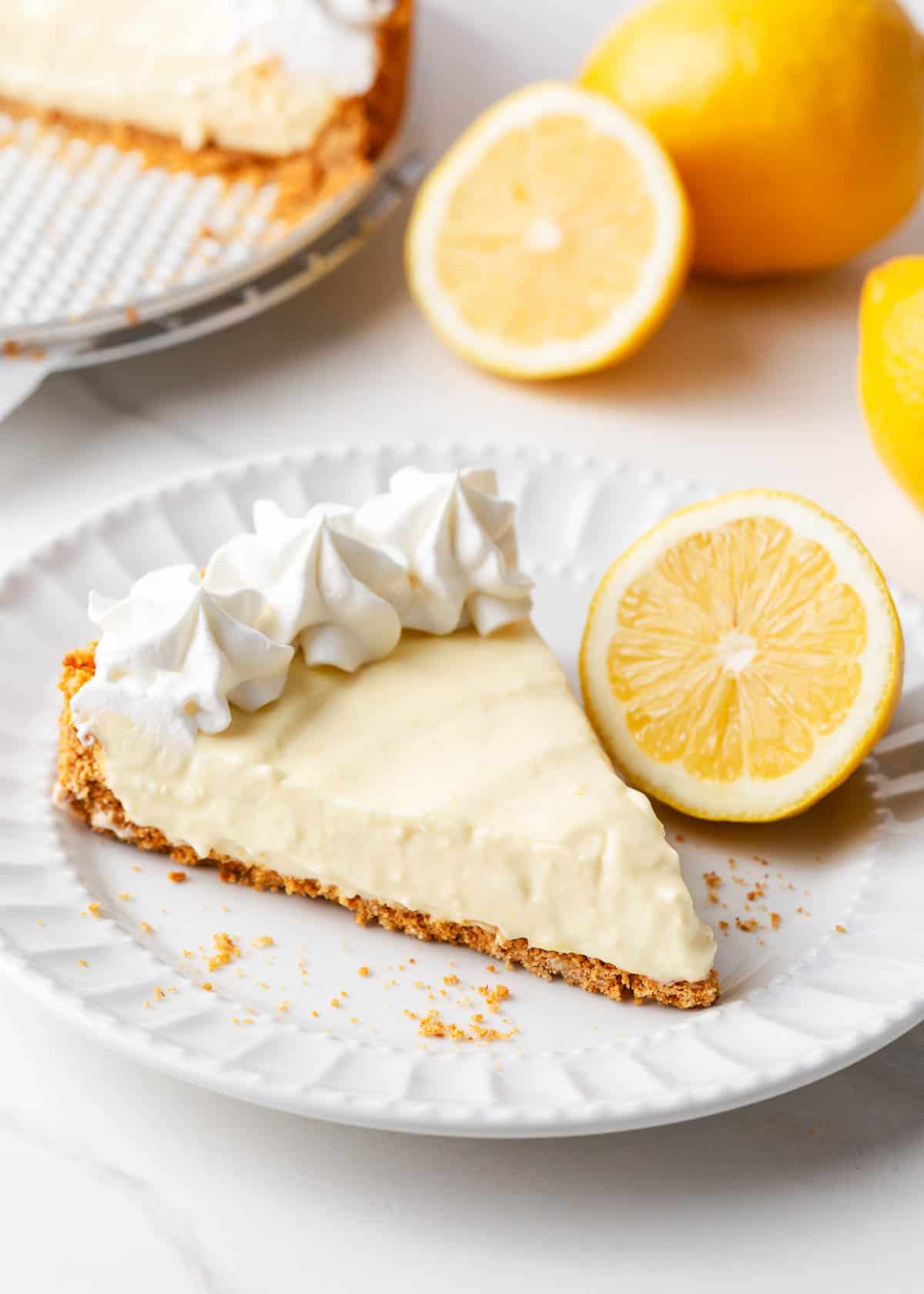 Slice of lemon icebox pie on a white plate.