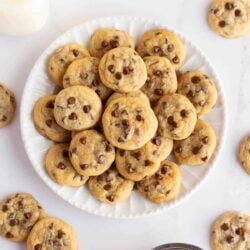 Mini chocolate chip cookies on a white plate.