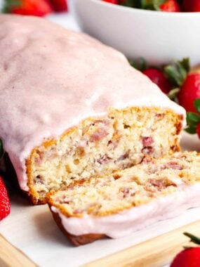 Sliced strawberry quick bread with strawberry glaze.