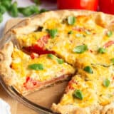 Sliced tomato pie in a pie dish.