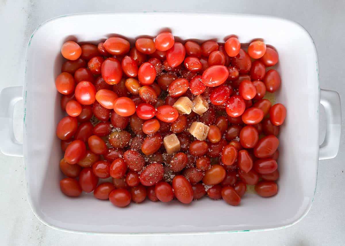 Baked feta pasta ingredients in white dish.